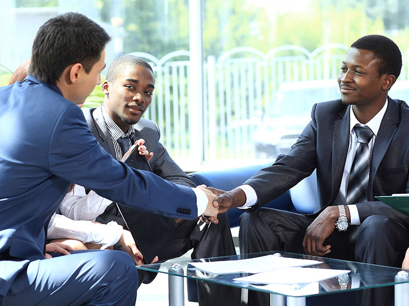 Bankers Shaking Hands Across Table